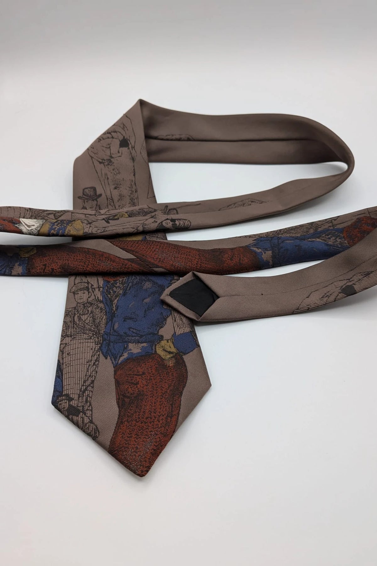 Uomo brown tie vintage illustrated pattern with blue, bordeaux, and ochre details.