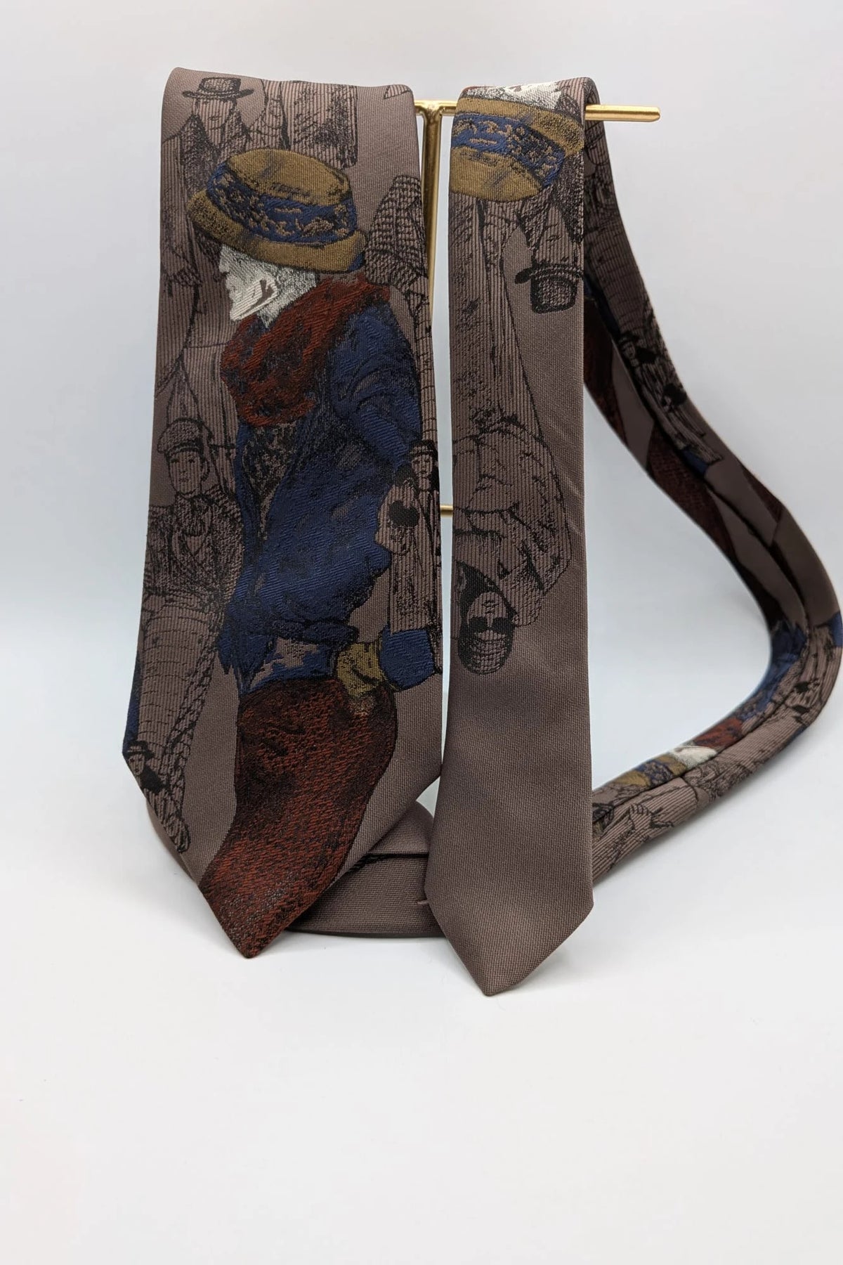 Uomo brown tie vintage illustrated pattern with blue, bordeaux, and ochre details.