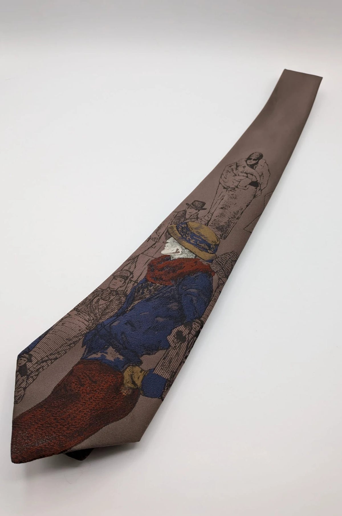 Uomo brown tie vintage illustrated pattern with blue, bordeaux, and ochre details.