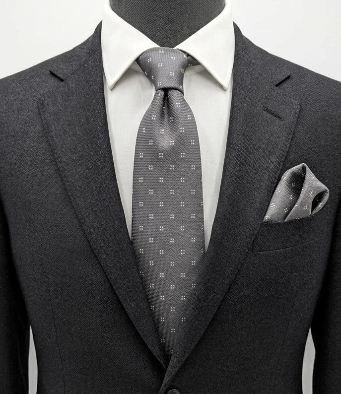Prochownick grey silk tie with ivory geometric pattern and 8 cm wide blade.