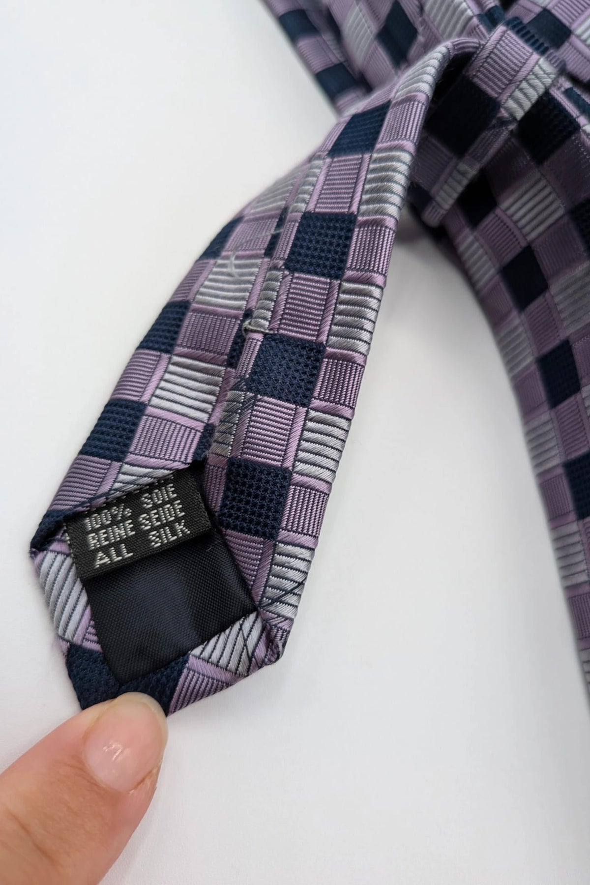 Uomo navy tie 100% silk geometric plaid pattern in purple and gray.