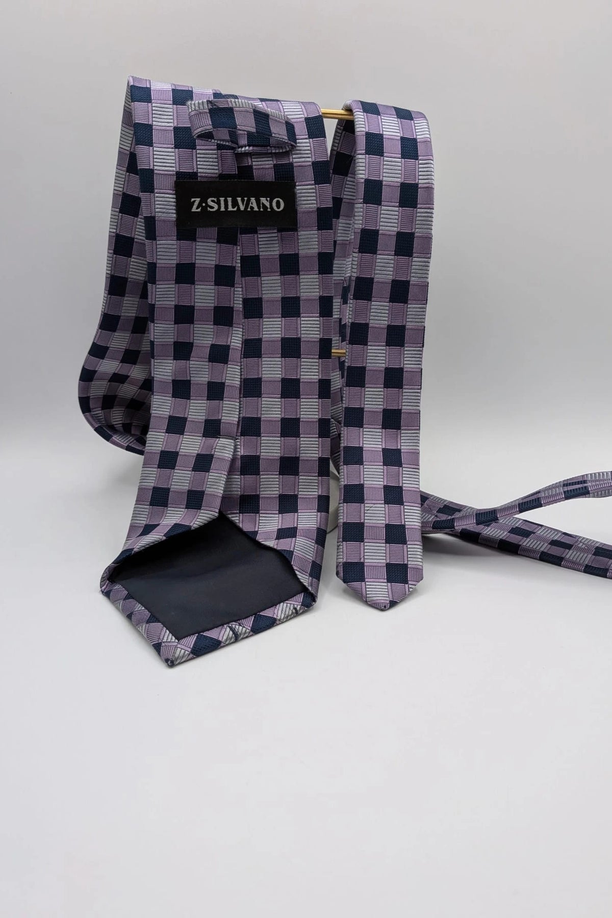 Uomo navy tie 100% silk geometric plaid pattern in purple and gray.