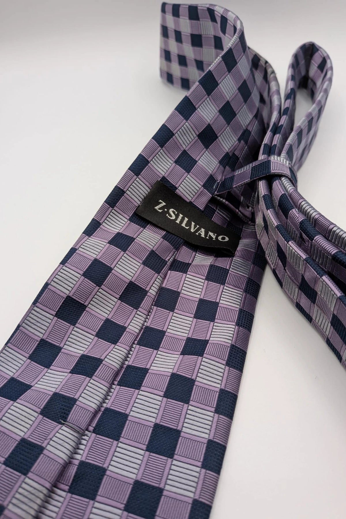 Uomo navy tie 100% silk geometric plaid pattern in purple and gray.