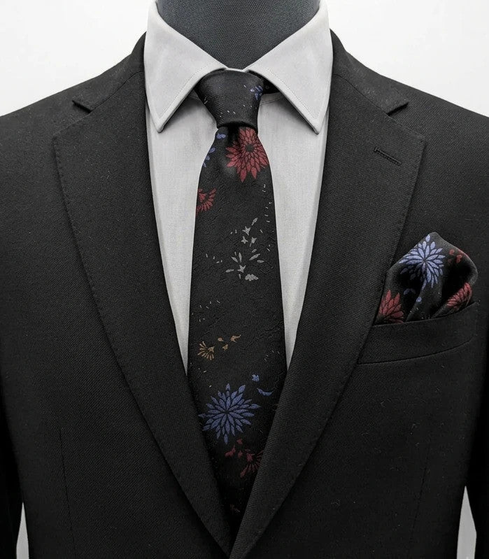 Uomo black tie with red and blue floral pattern, "Misto Seta" label, Made in Italy.