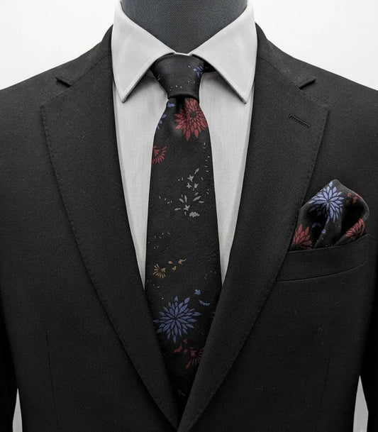 Uomo black tie with red and blue floral pattern, "Misto Seta" label, Made in Italy.
