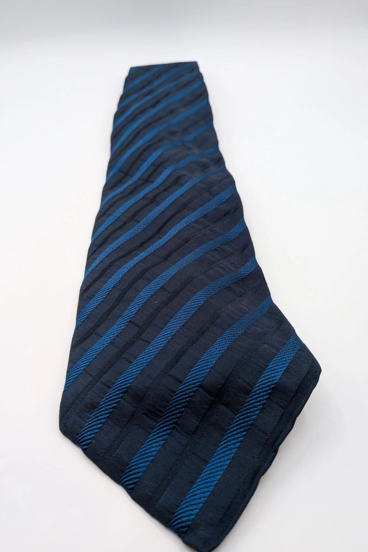 Uomo blue striped tie 100% silk with diagonal light blue and navy stripes.