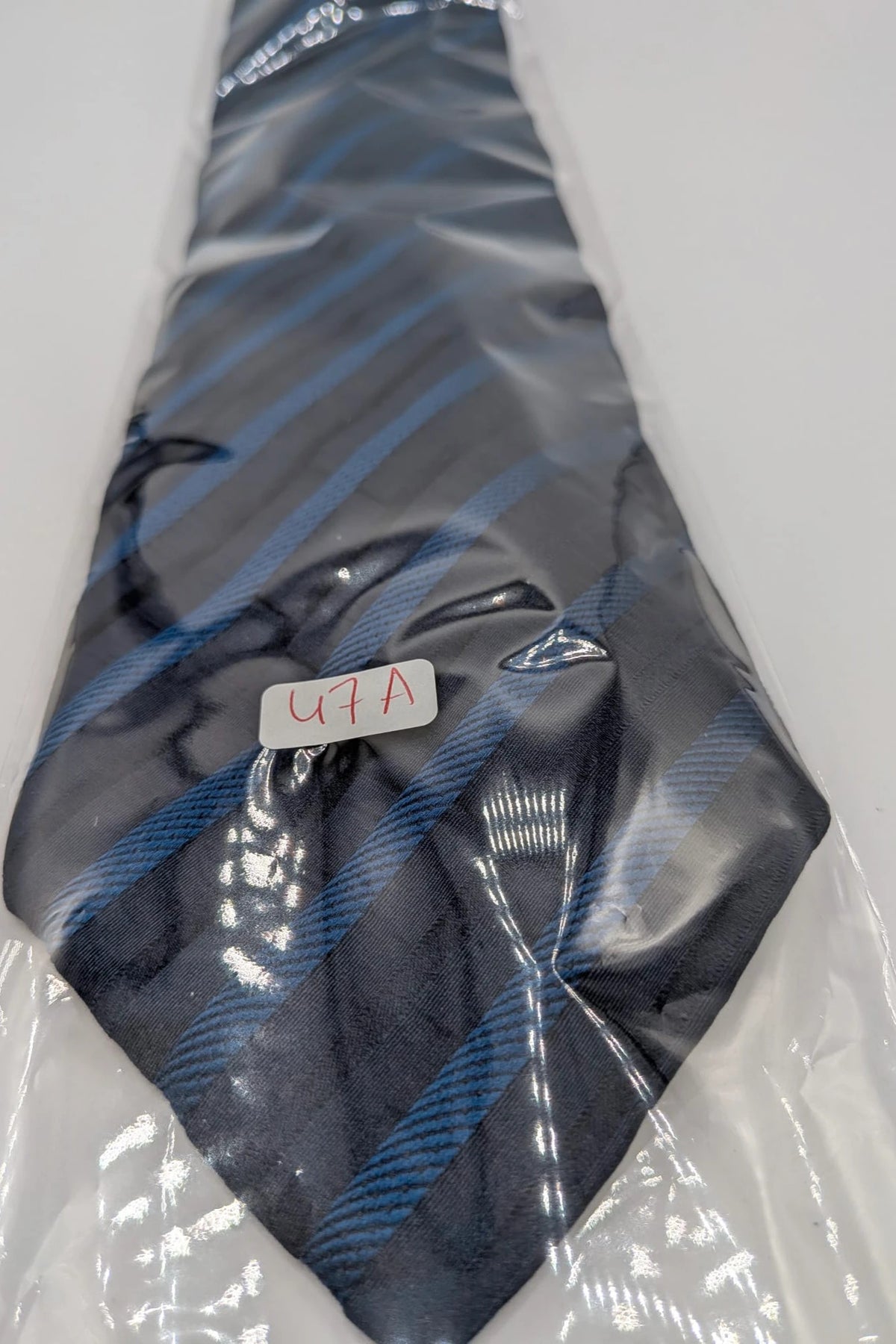 Uomo blue striped tie 100% silk with diagonal light blue and navy stripes.