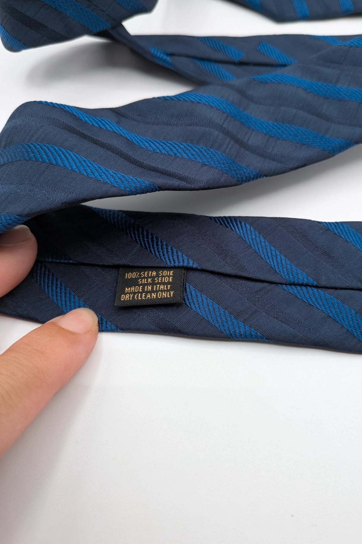Uomo blue striped tie 100% silk with diagonal light blue and navy stripes.