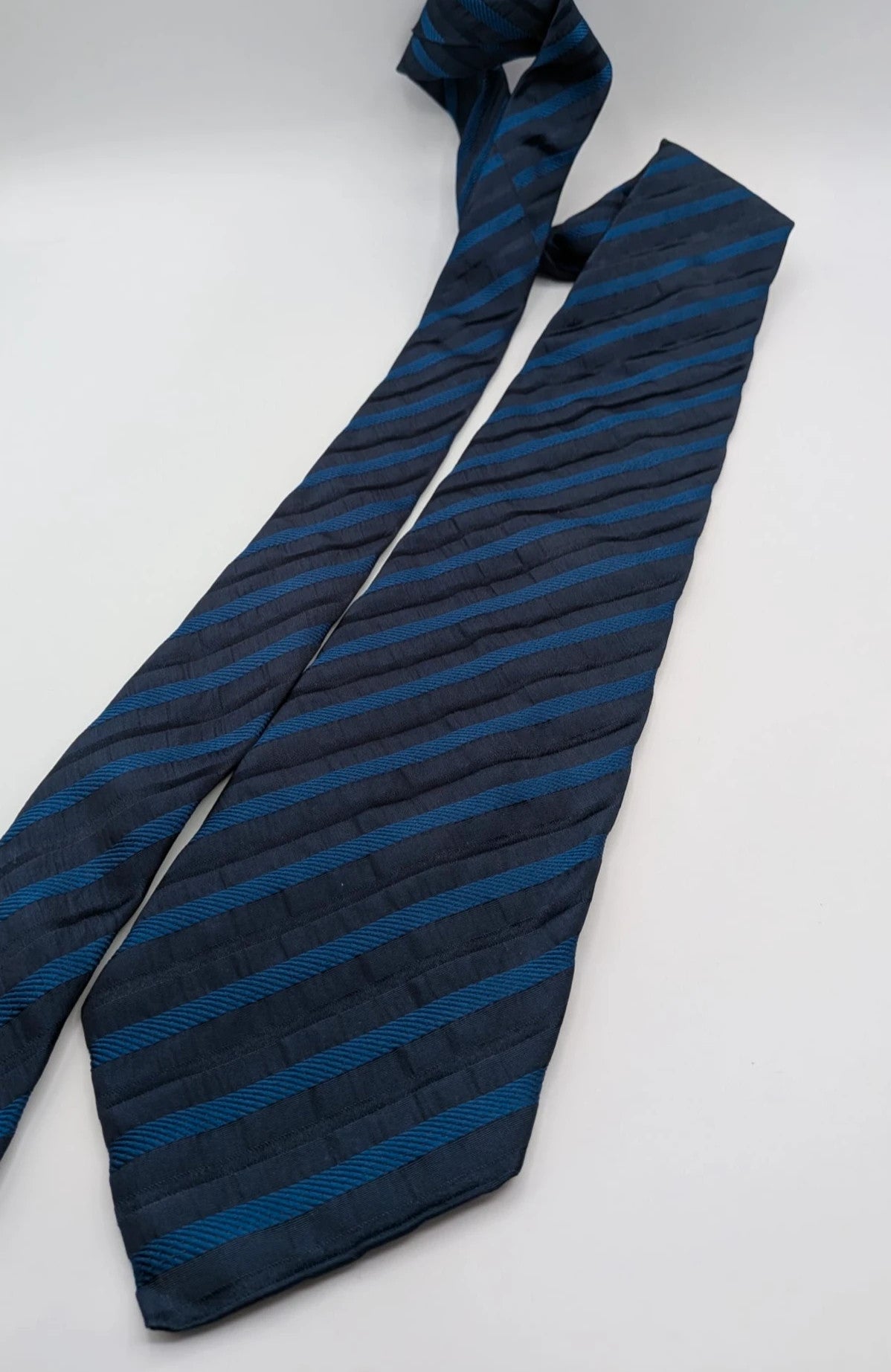 Uomo blue striped tie 100% silk with diagonal light blue and navy stripes.