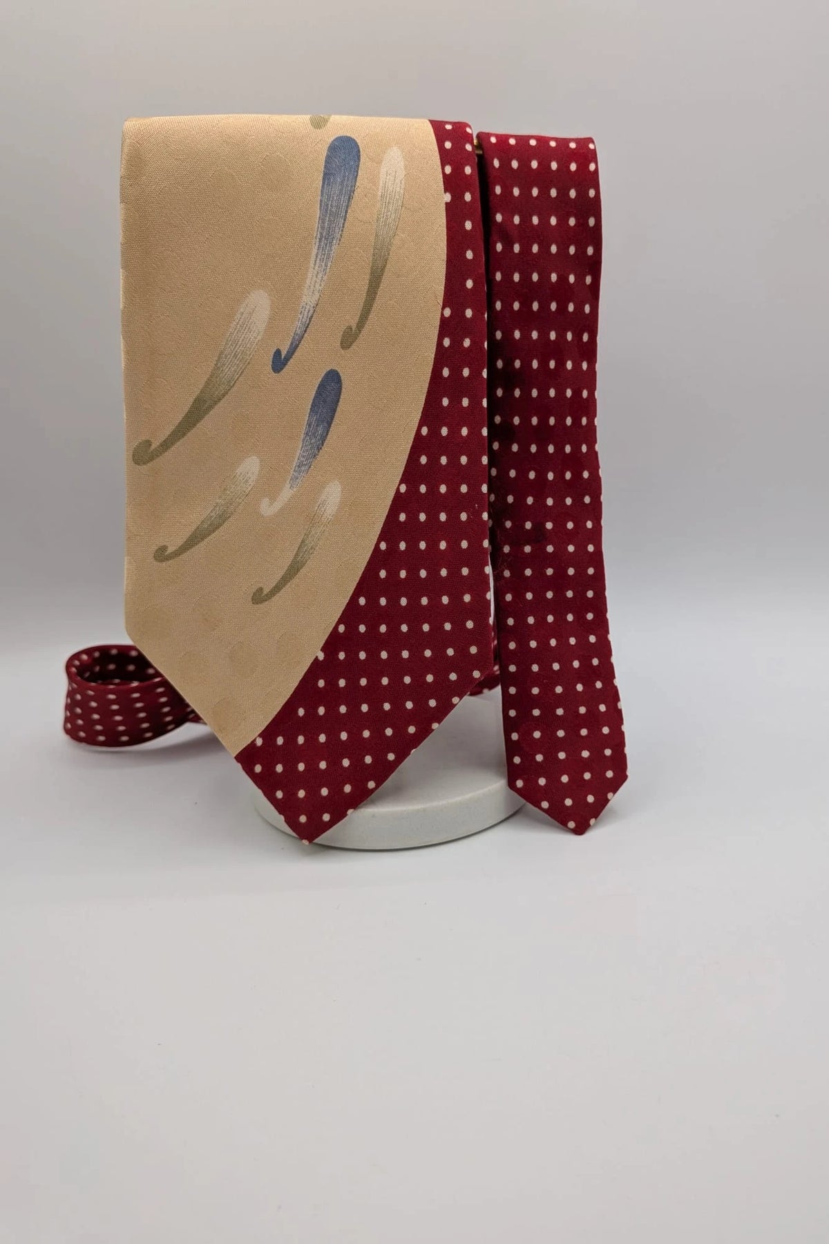 Renoma beige and burgundy tie with ivory polka dots and abstract blue-green designs.