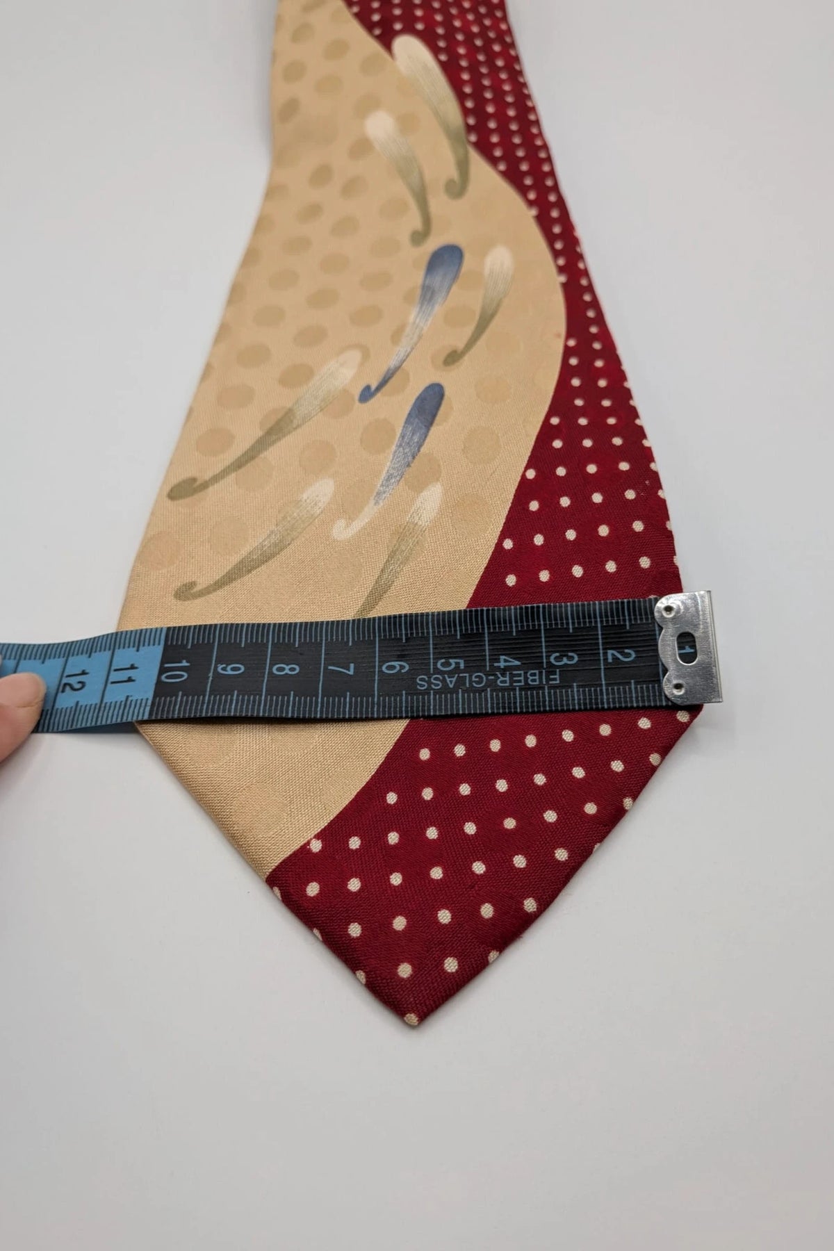 Renoma beige and burgundy tie with ivory polka dots and abstract blue-green designs.