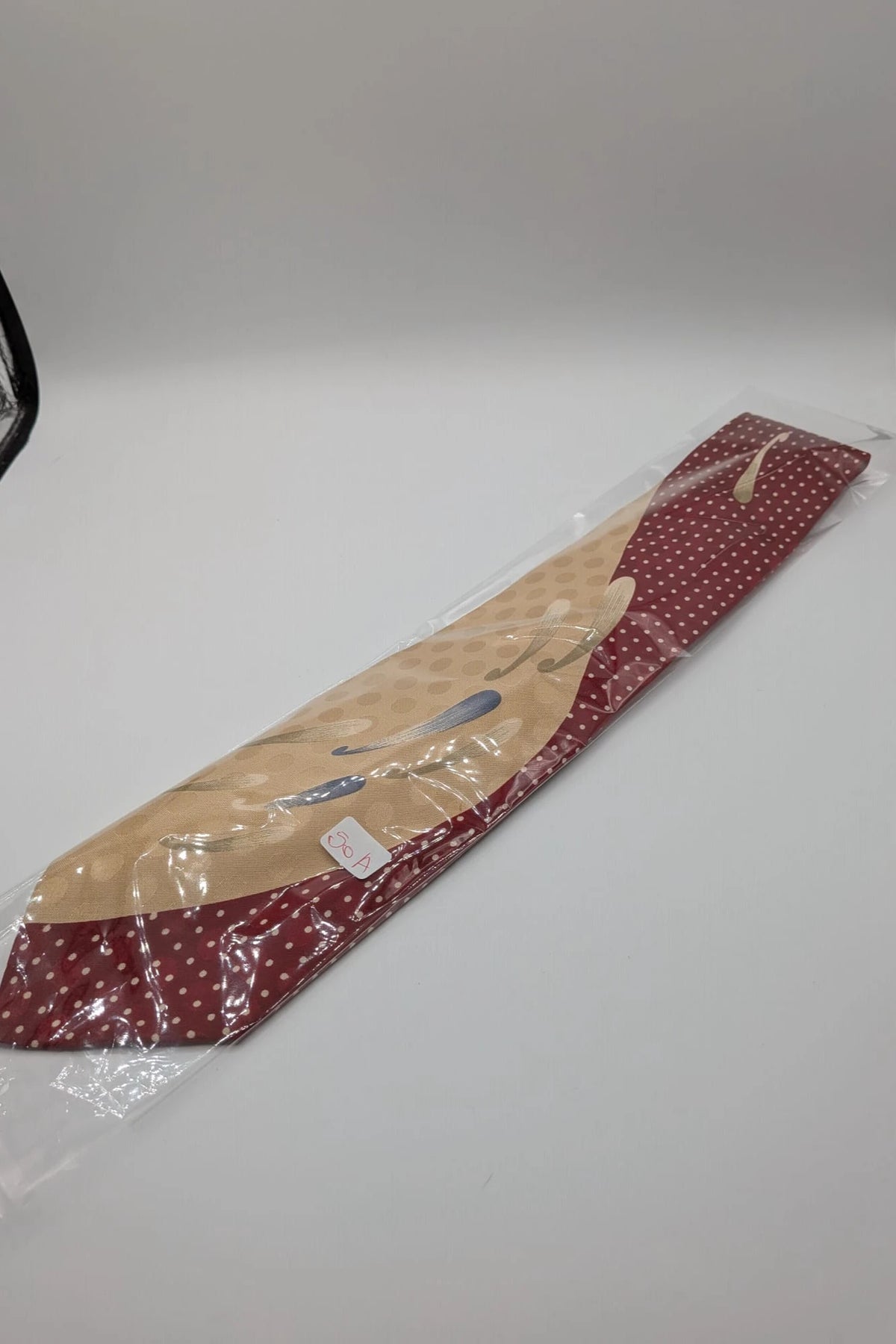 Renoma beige and burgundy tie with ivory polka dots and abstract blue-green designs.