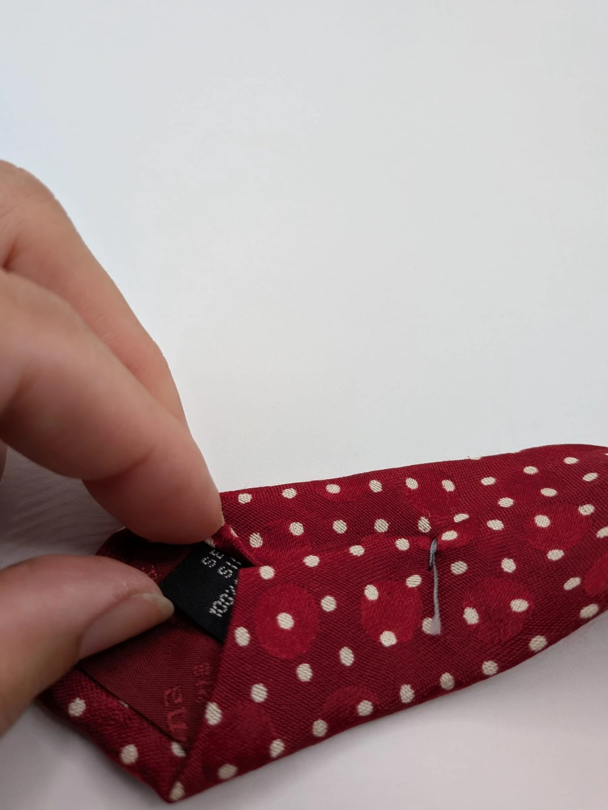 Renoma beige and burgundy tie with ivory polka dots and abstract blue-green designs.