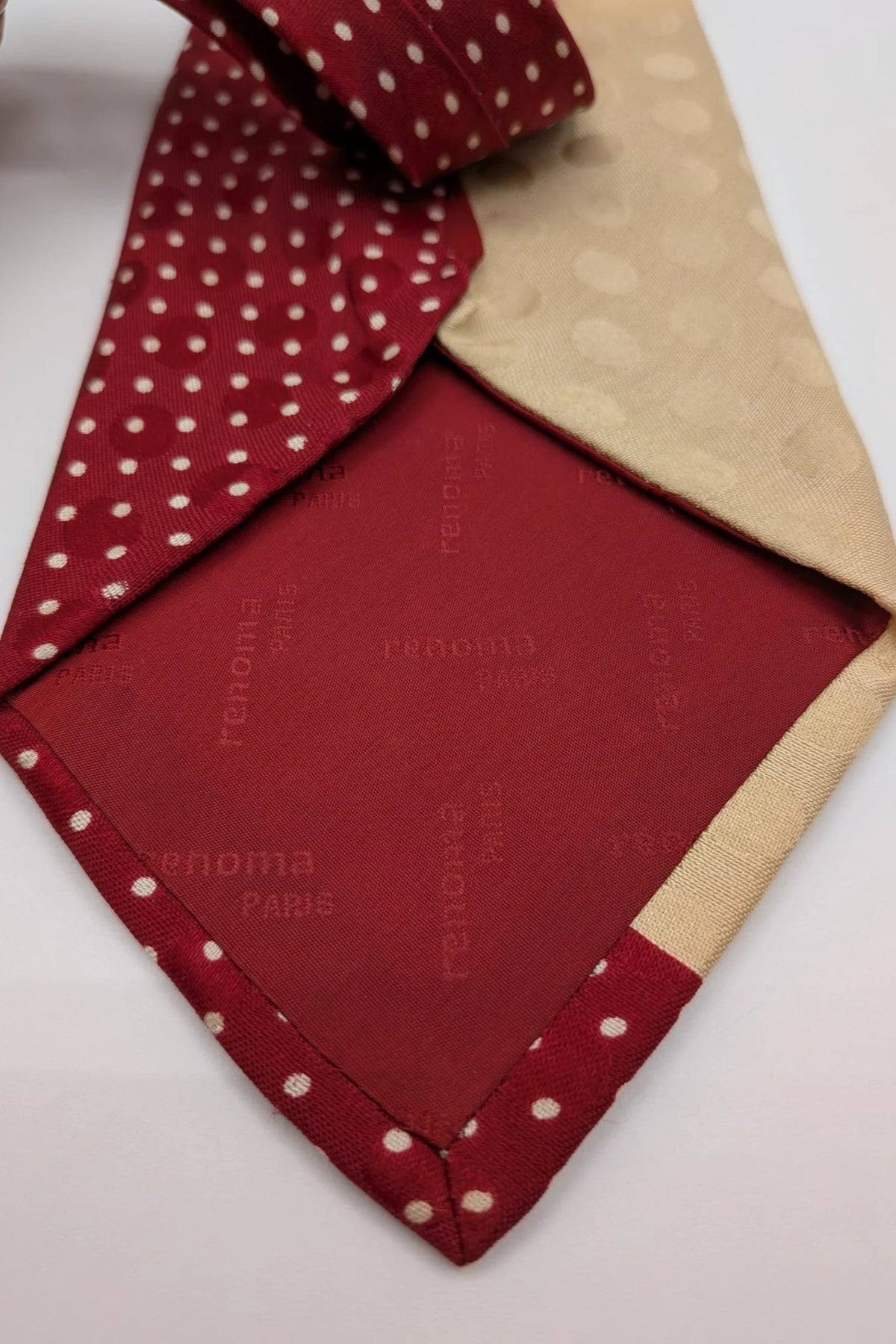 Renoma beige and burgundy tie with ivory polka dots and abstract blue-green designs.