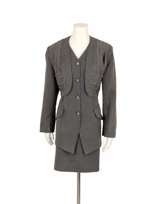 M-Made in Italy grey skirt suit with pleated jacket and decorative buttons.