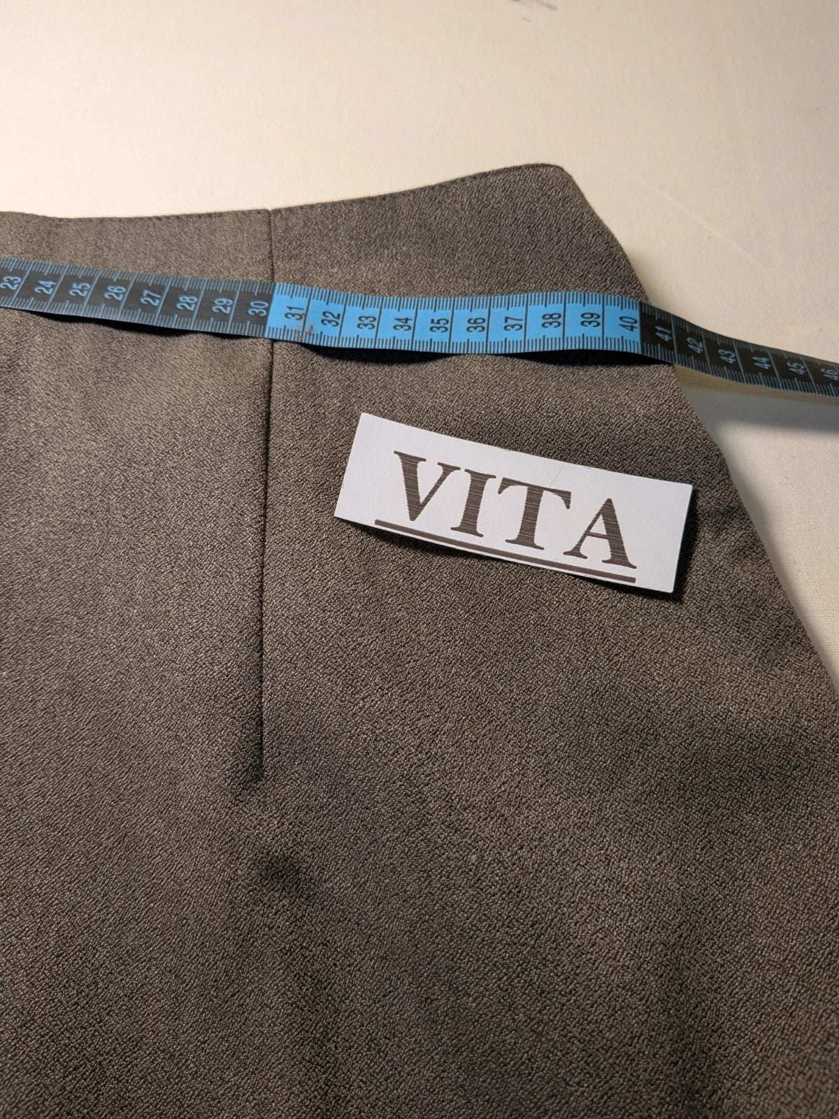 M-Made in Italy grey skirt suit with pleated jacket and decorative buttons.