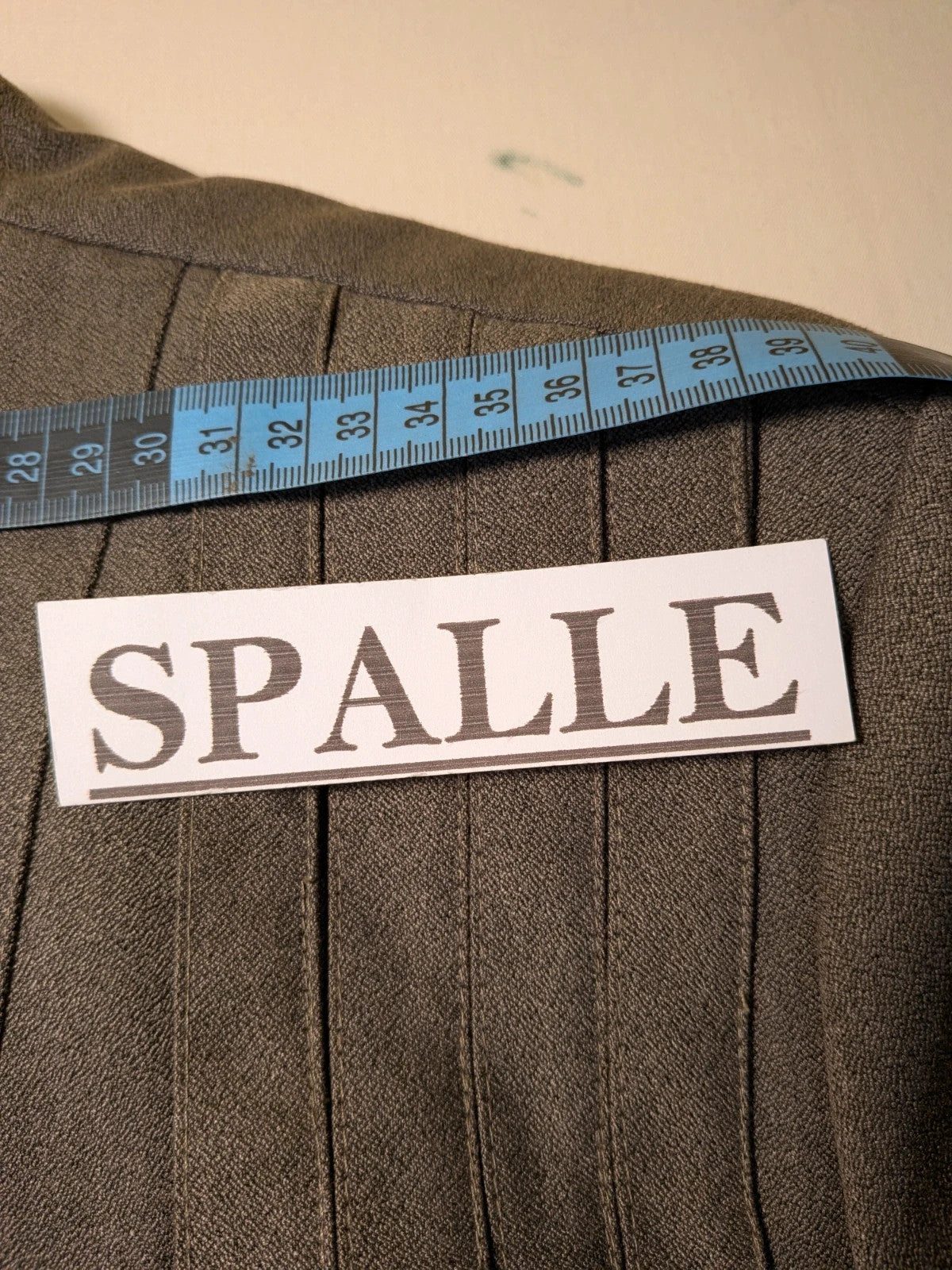M-Made in Italy grey skirt suit with pleated jacket and decorative buttons.