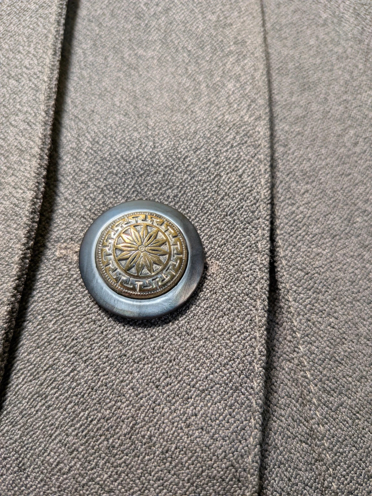 M-Made in Italy grey skirt suit with pleated jacket and decorative buttons.