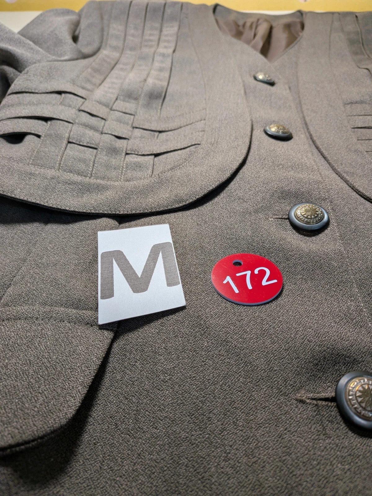 M-Made in Italy grey skirt suit with pleated jacket and decorative buttons.