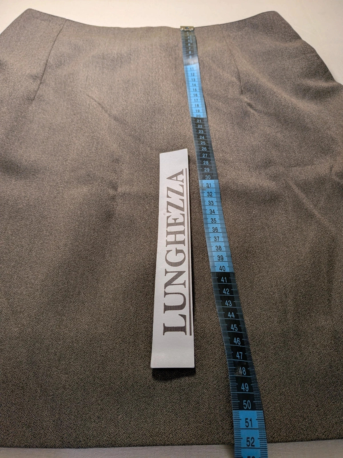 M-Made in Italy grey skirt suit with pleated jacket and decorative buttons.