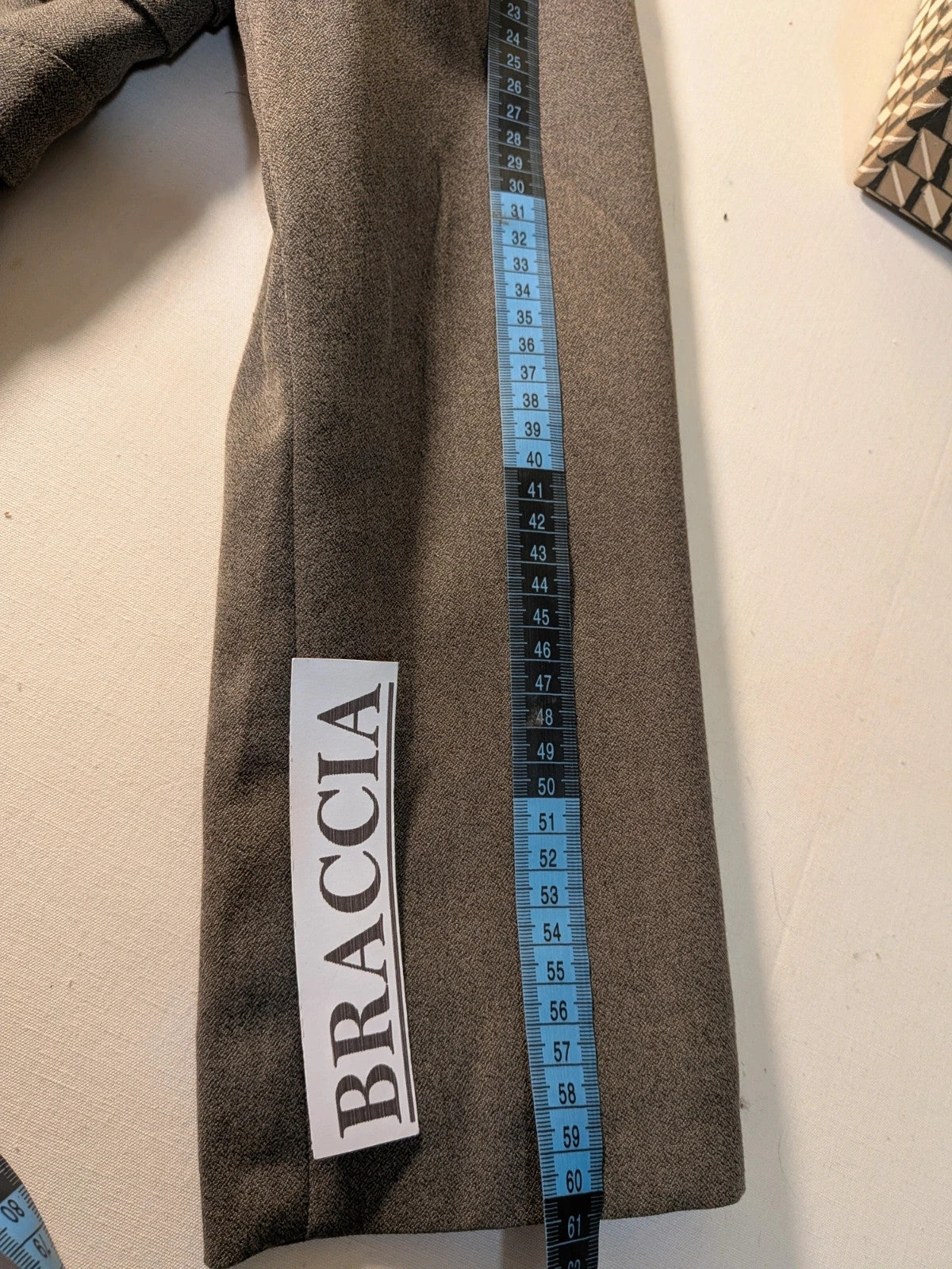 M-Made in Italy grey skirt suit with pleated jacket and decorative buttons.
