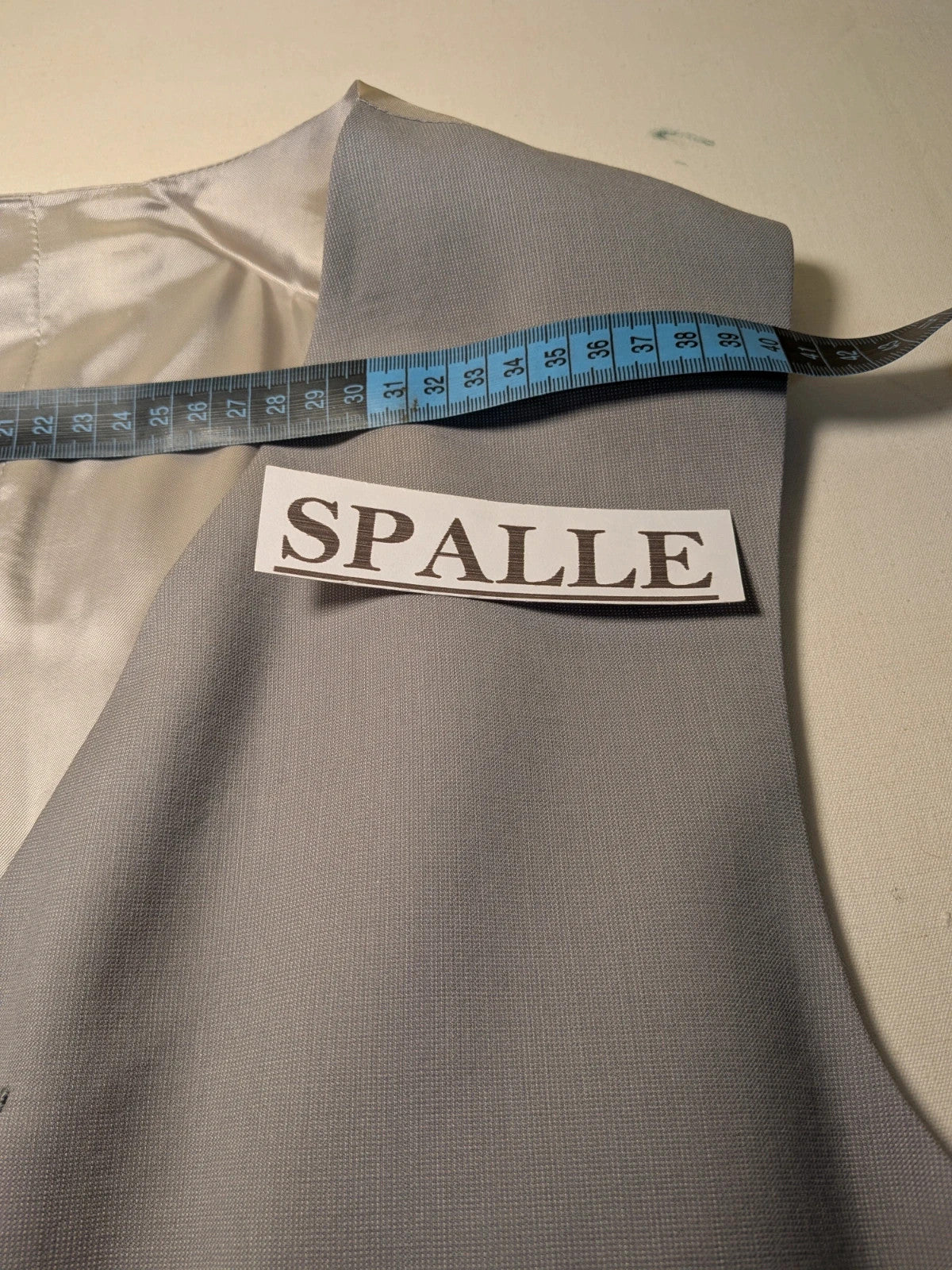 Elegante grey jacket gilet with covered button front and front pockets.