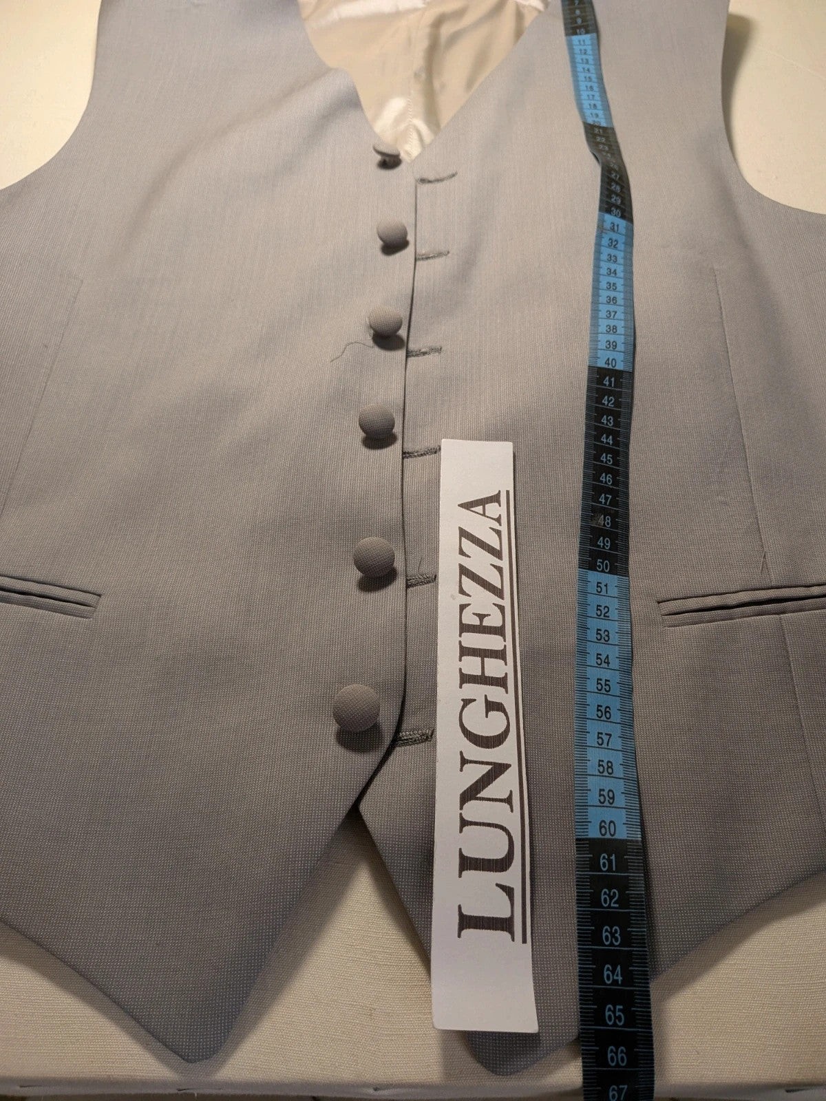 Elegante grey jacket gilet with covered button front and front pockets.