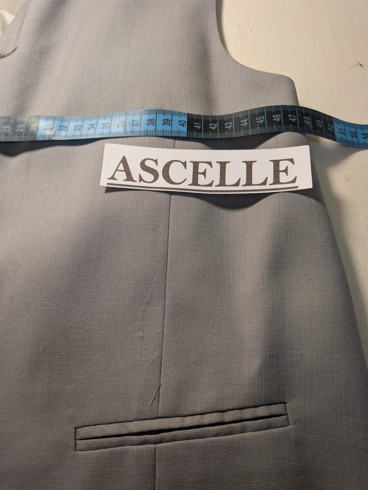 Elegante grey jacket gilet with covered button front and front pockets.