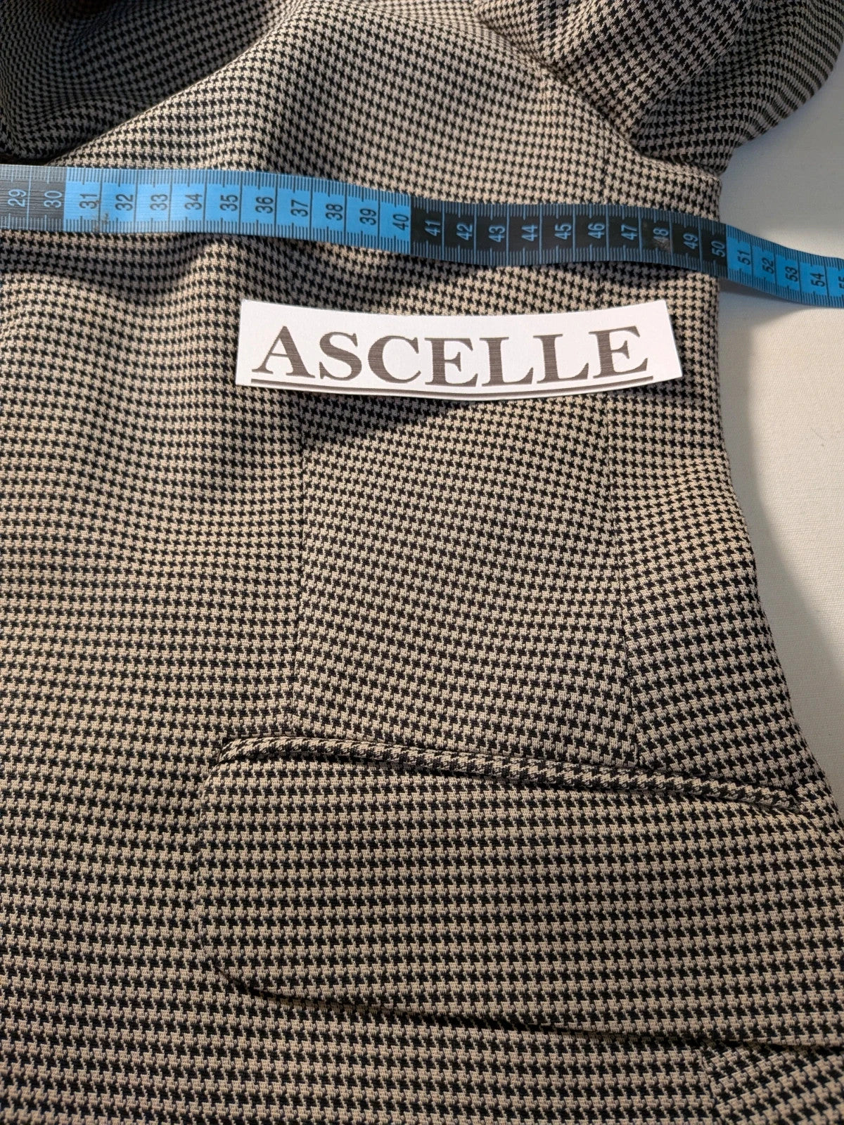 Luca D'Altieri beige and black skirt suit, micro pied de poule pattern, elegant design.