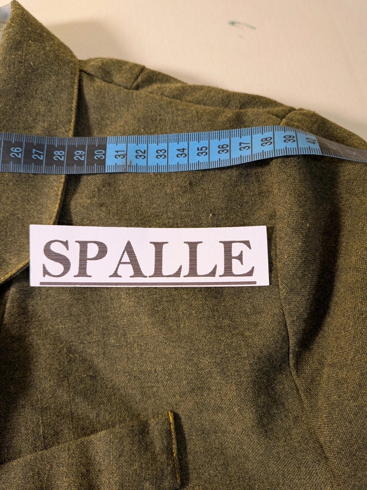 Oliva khaki skirt suit Freeling with textured fabric, short sleeve jacket, and sleeveless dress.