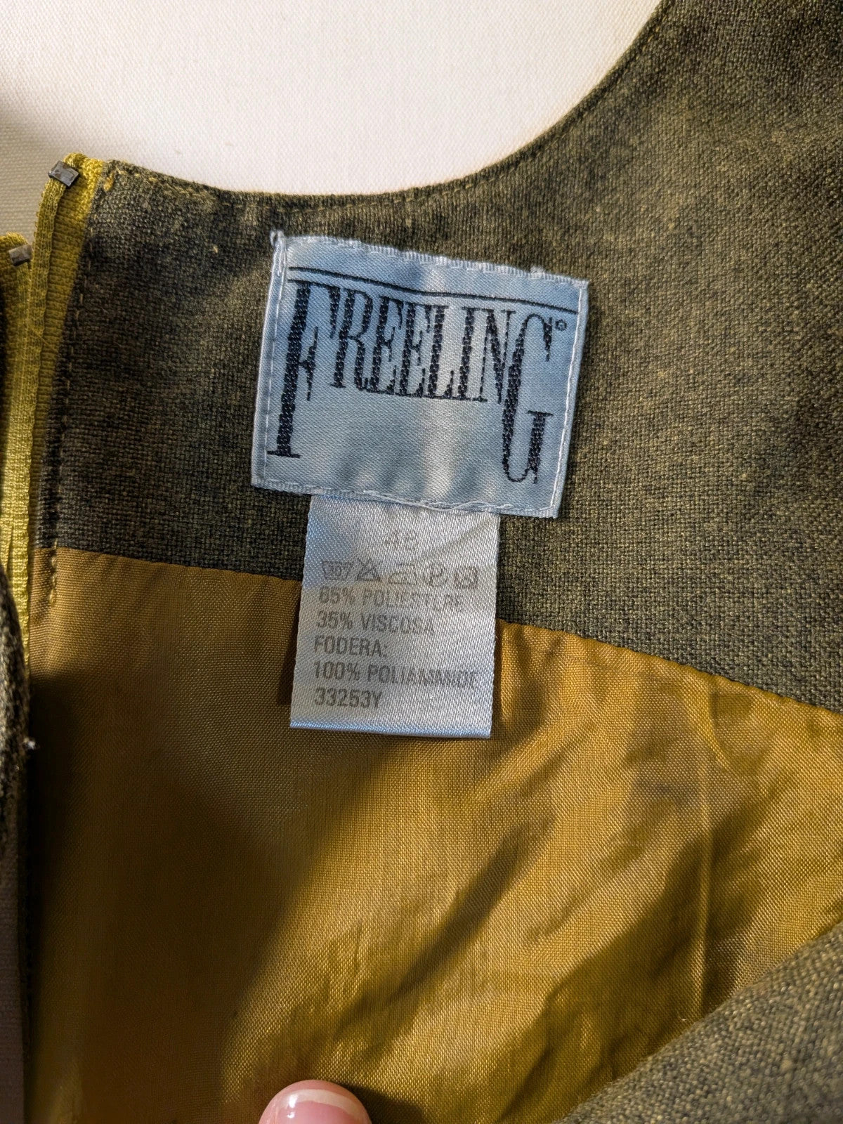 Oliva khaki skirt suit Freeling with textured fabric, short sleeve jacket, and sleeveless dress.