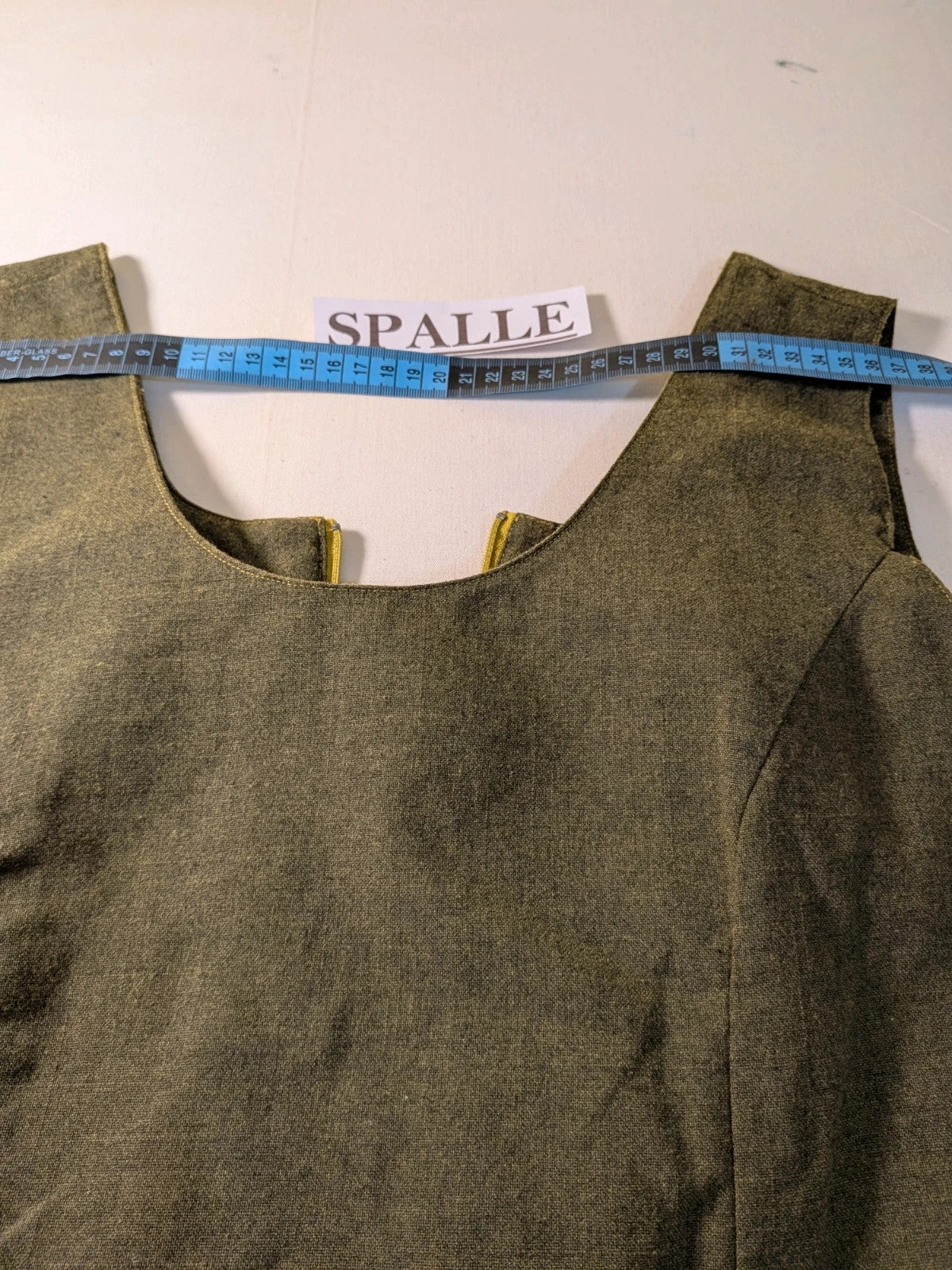 Oliva khaki skirt suit Freeling with textured fabric, short sleeve jacket, and sleeveless dress.