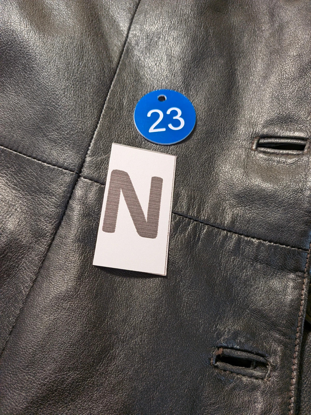 Vera Pelle black vintage leather jacket with three-button closure and Wild Cats logo.