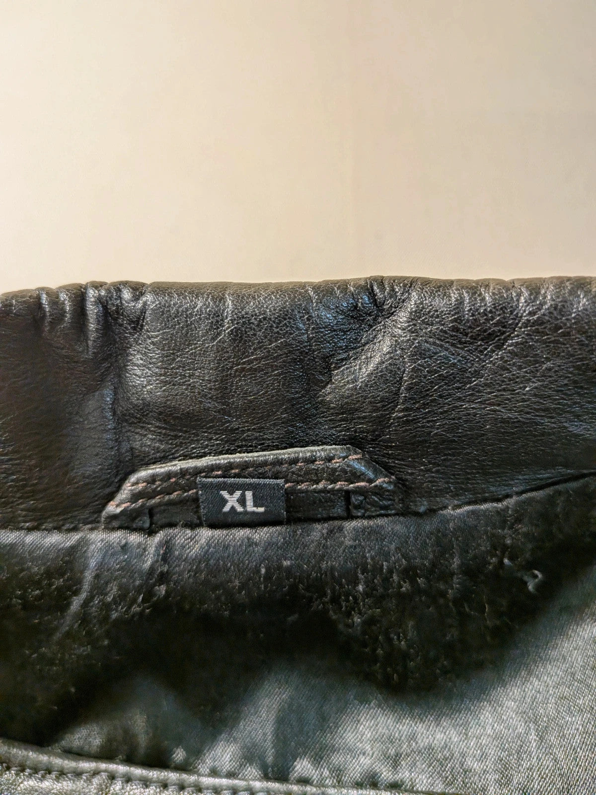 Vera Pelle black vintage leather jacket with three-button closure and Wild Cats logo.