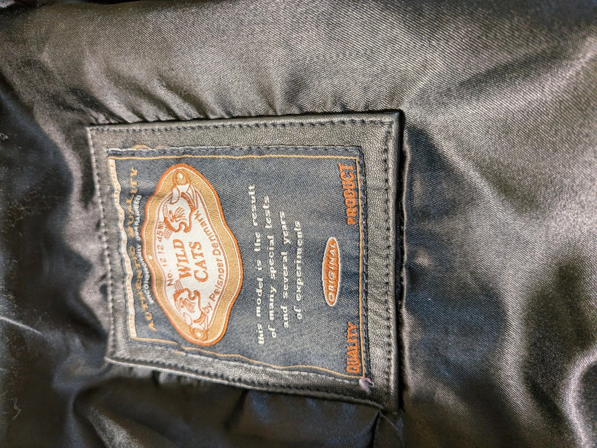 Vera Pelle black vintage leather jacket with three-button closure and Wild Cats logo.
