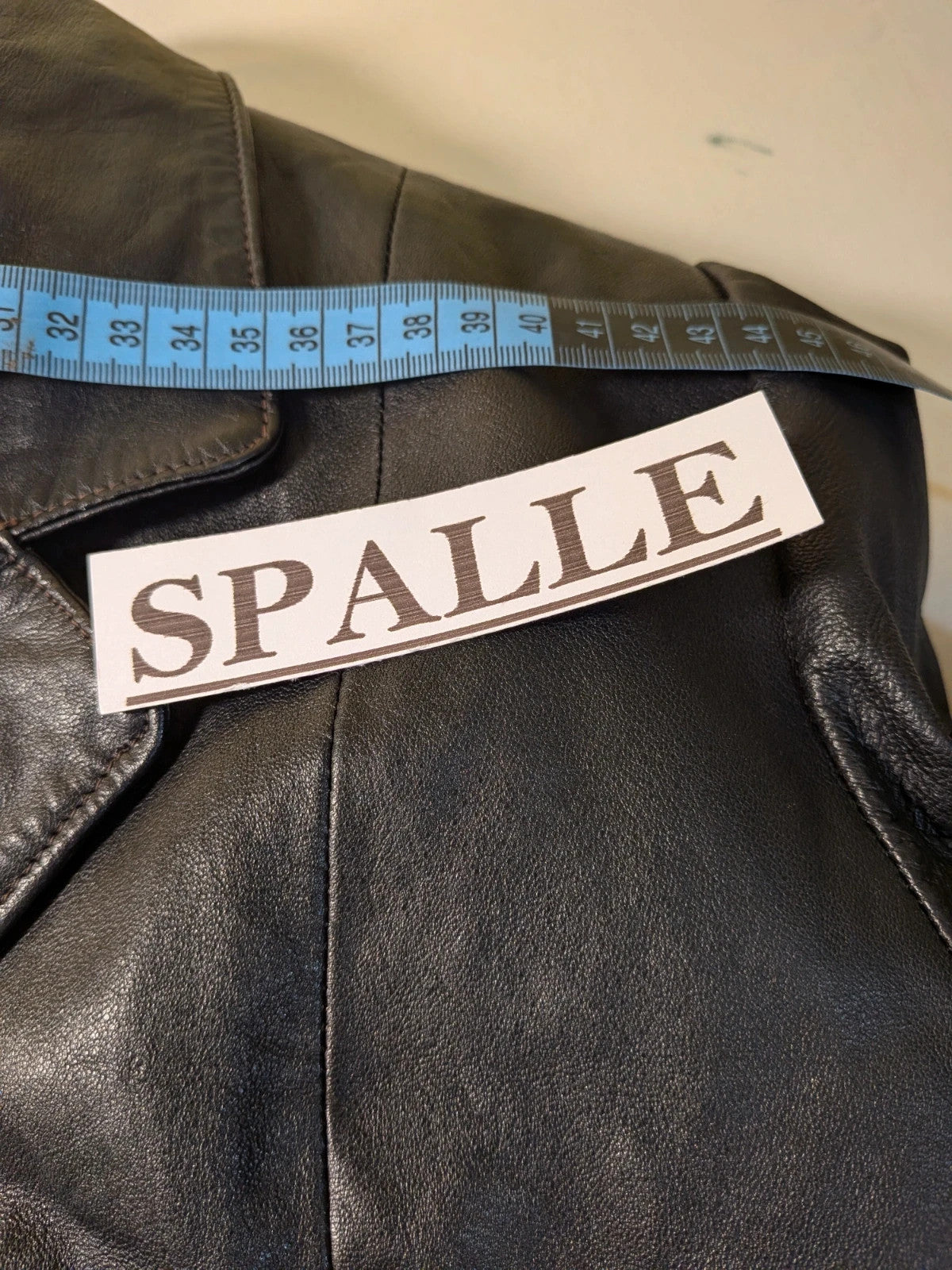 Vera Pelle black vintage leather jacket with three-button closure and Wild Cats logo.