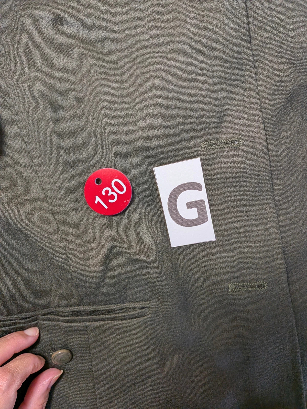 Persona green skirt suit with structured long-sleeve jacket and front buttons, 100% virgin wool.