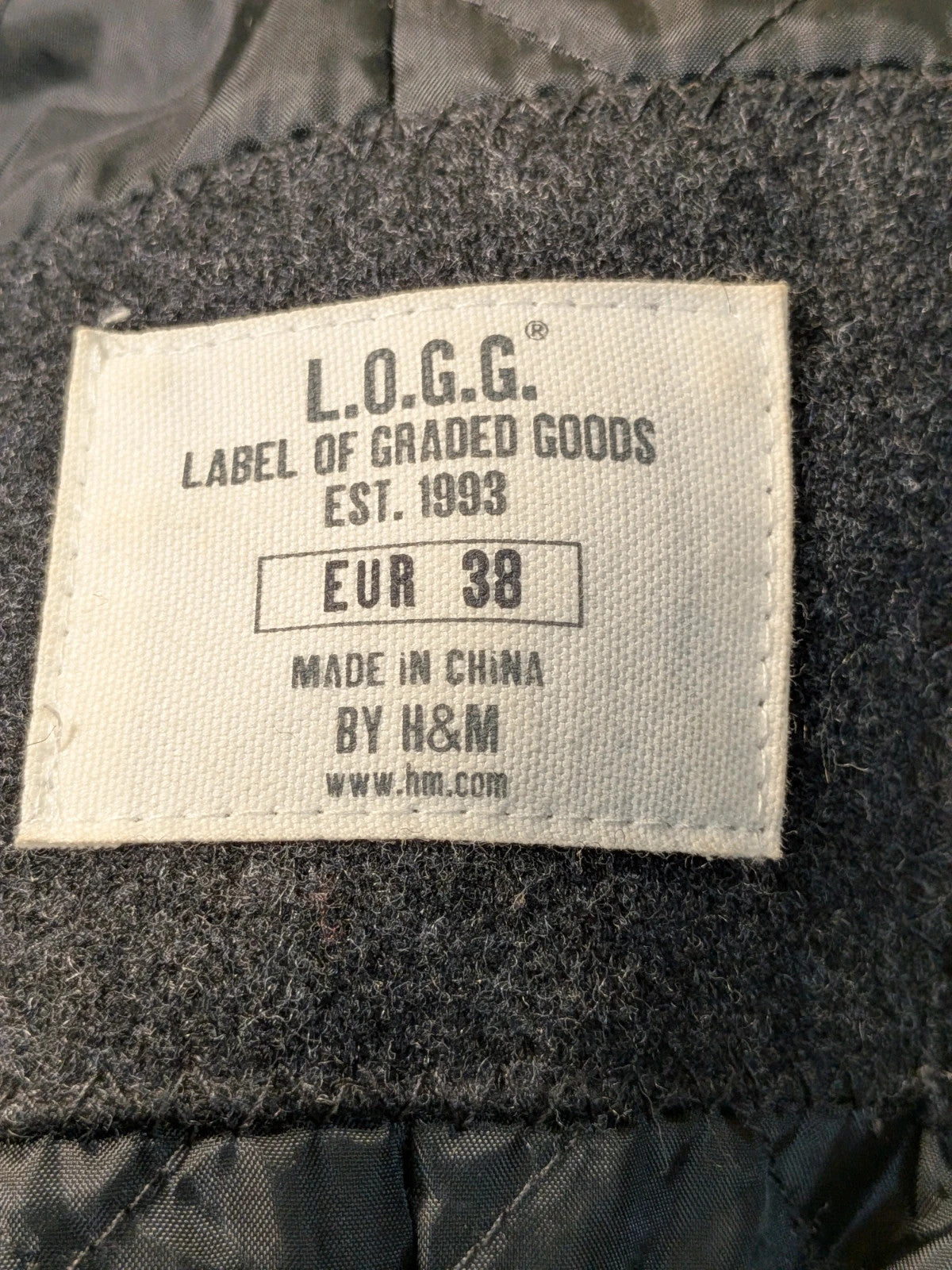 L.O.G.G. grey wool blend double-breasted coat with large lapels and quilted lining.