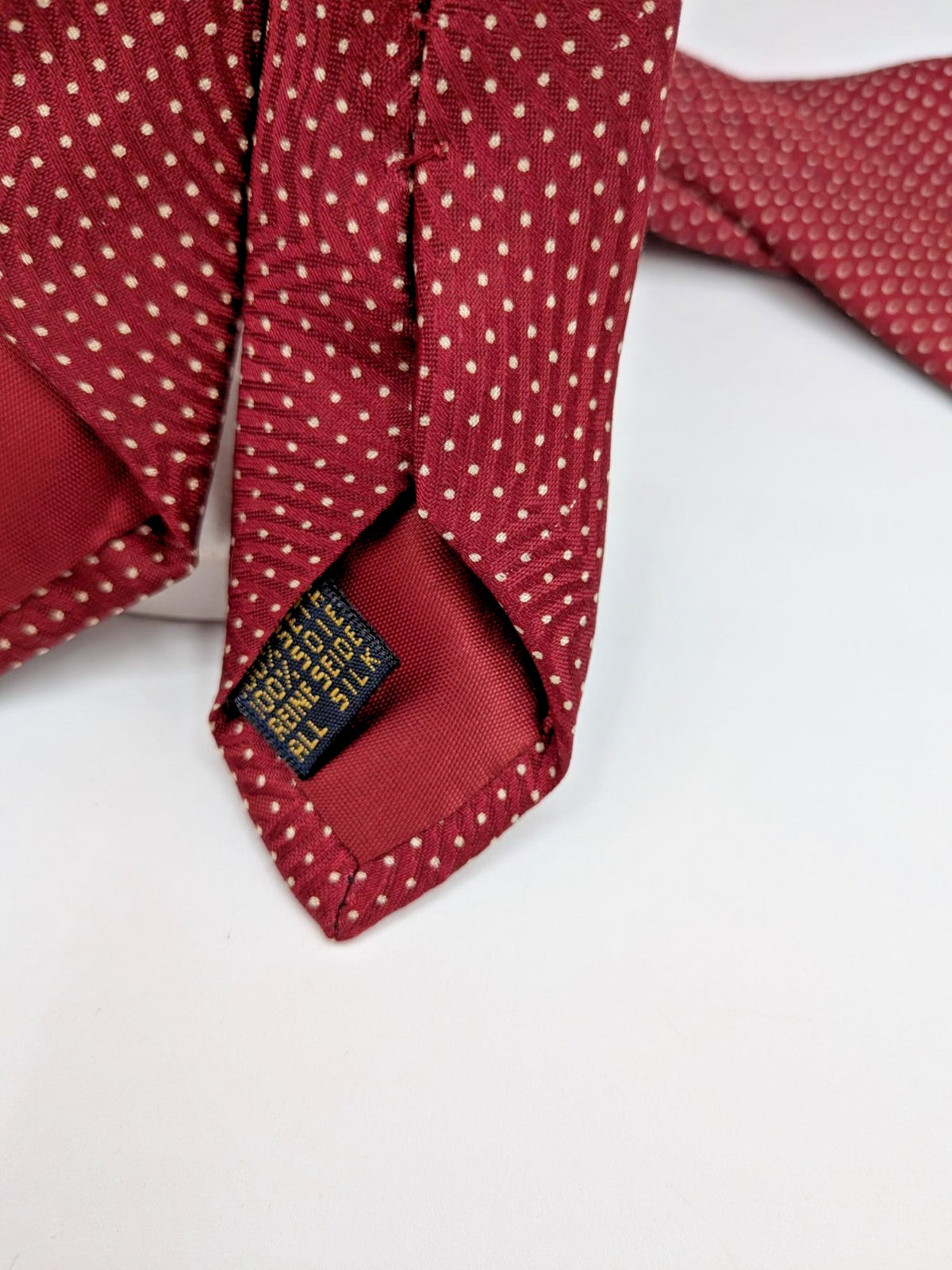 Bordeaux navy necktie 100% silk with cream polka dot pattern and original label.