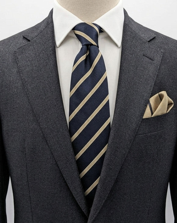 Blazer beige necktie with navy diagonal stripes and classic regimental pattern.