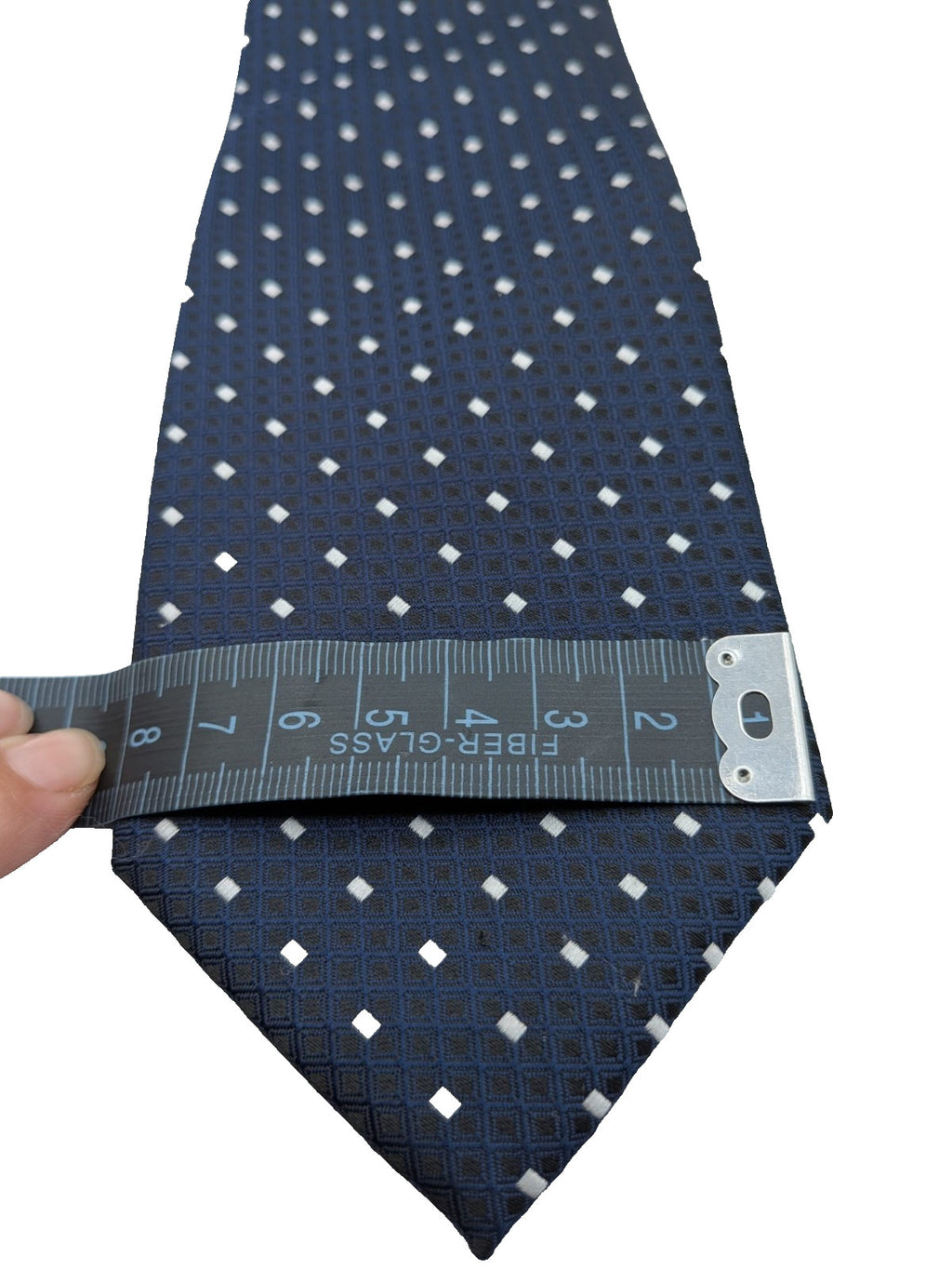 Uomo navy necktie with jacquard polka dot pattern and classic pointed style.