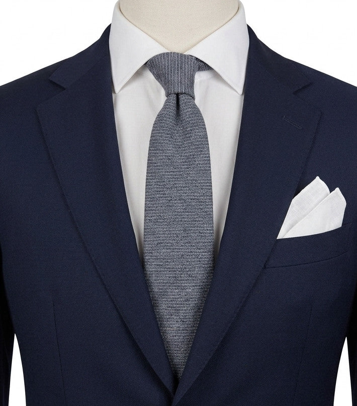 Uomo blue necktie made in Italy, textured wool fabric with elegant grey mélange pattern.
